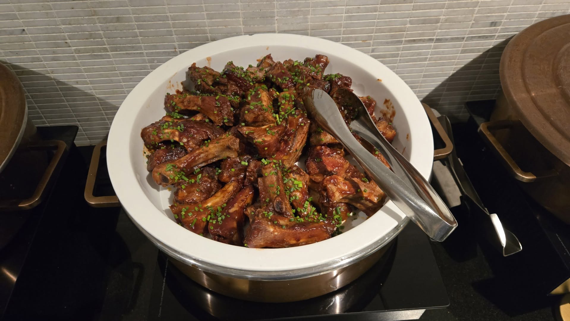 Chafing dish filled with slow-cooked barbecue glazed ribs