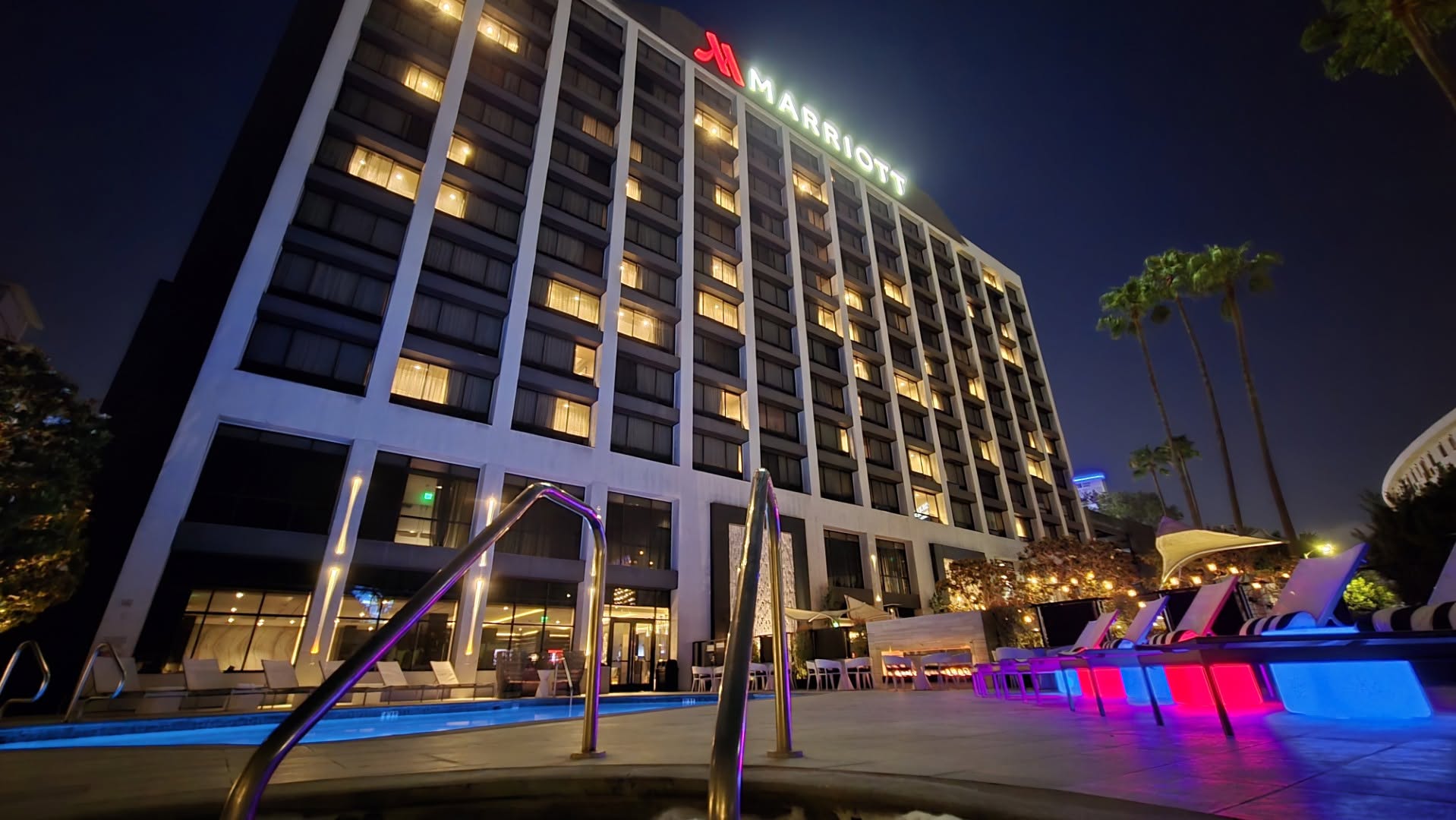 Illuminated Beverly Hills Marriott Tower across the pool and whirlpool at night
