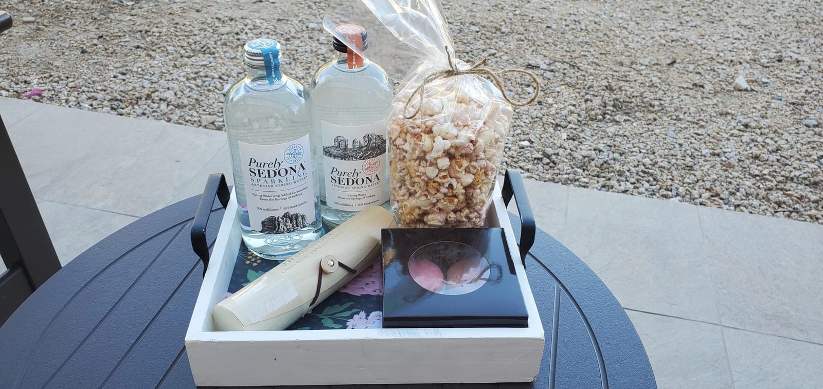 VIP Ambassador Elite welcome tray featuring Purely Sedona artesian waters, gourmet macarons, and welcome scroll. Ambassador Elite welcome amenity tray with Purely Sedona artesian waters, macarons, and scroll