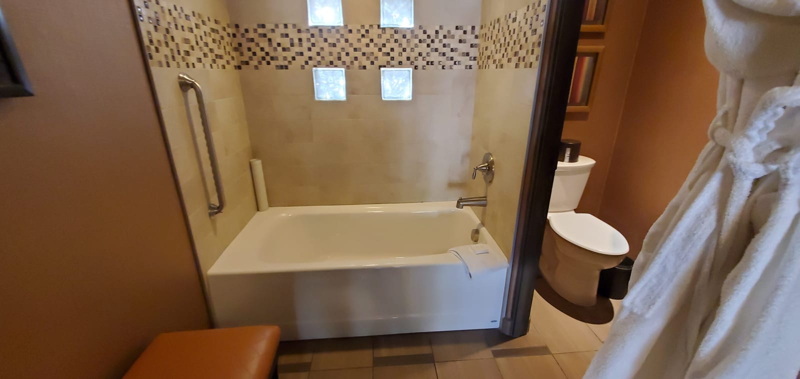 Deep soaking tub illuminated by architectural frosted glass block windows. Deep soaking tub beneath daylight glass blocks