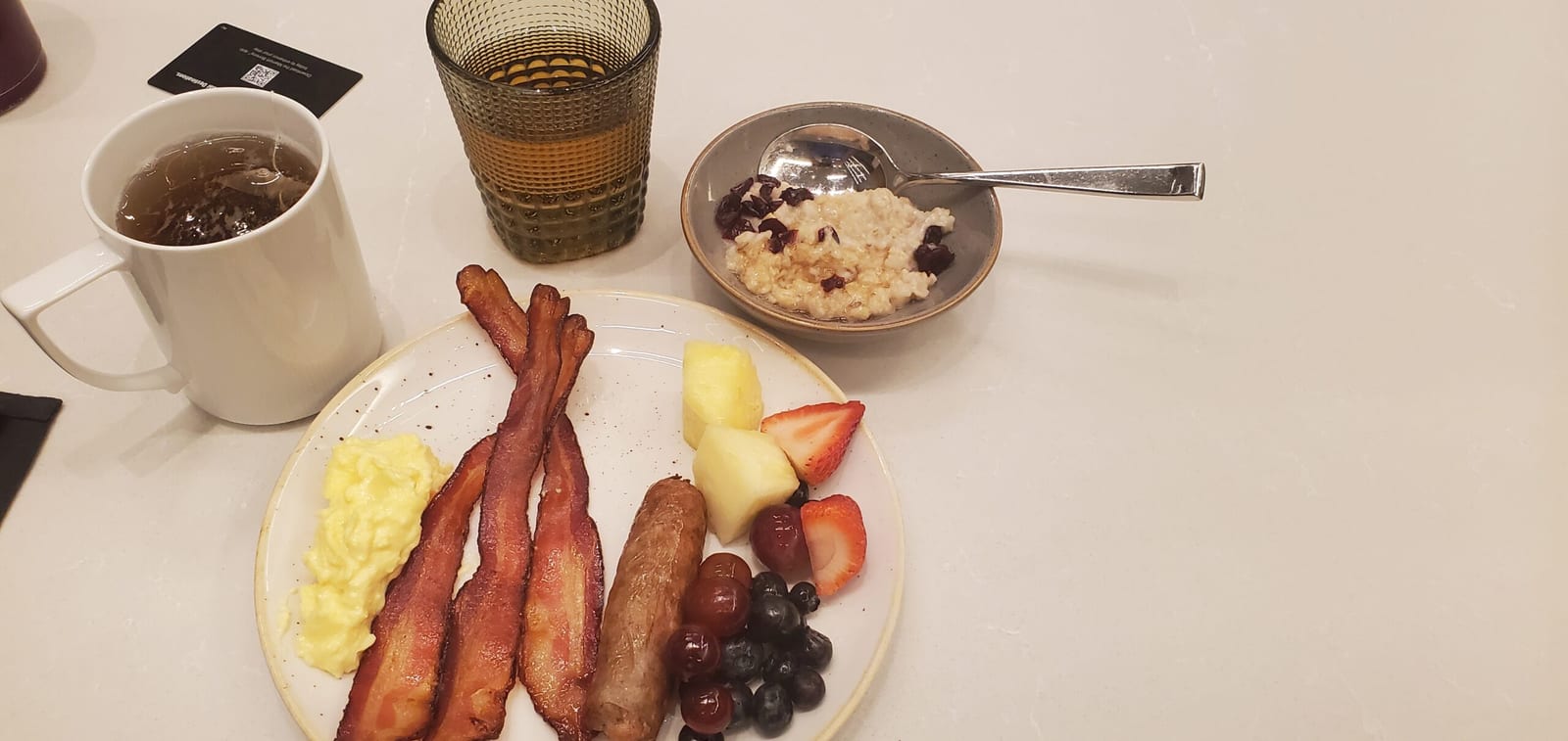 M Club hot breakfast plate with scrambled eggs, bacon, and breakfast potatoes